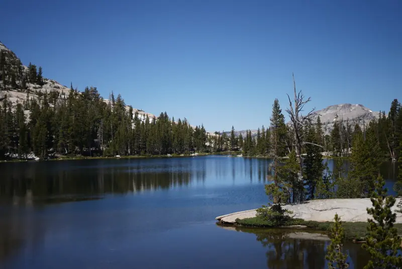 Granite ridges and pines under scattered clouds near Cathedral Lakes