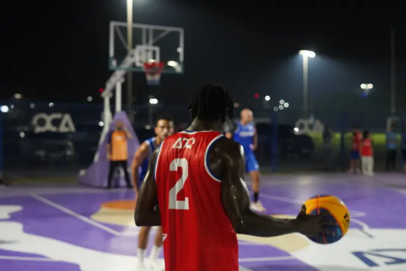 A night basketball game under floodlights