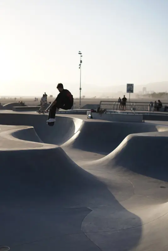 A skater on the edge of a concrete bowl in Santa Monica